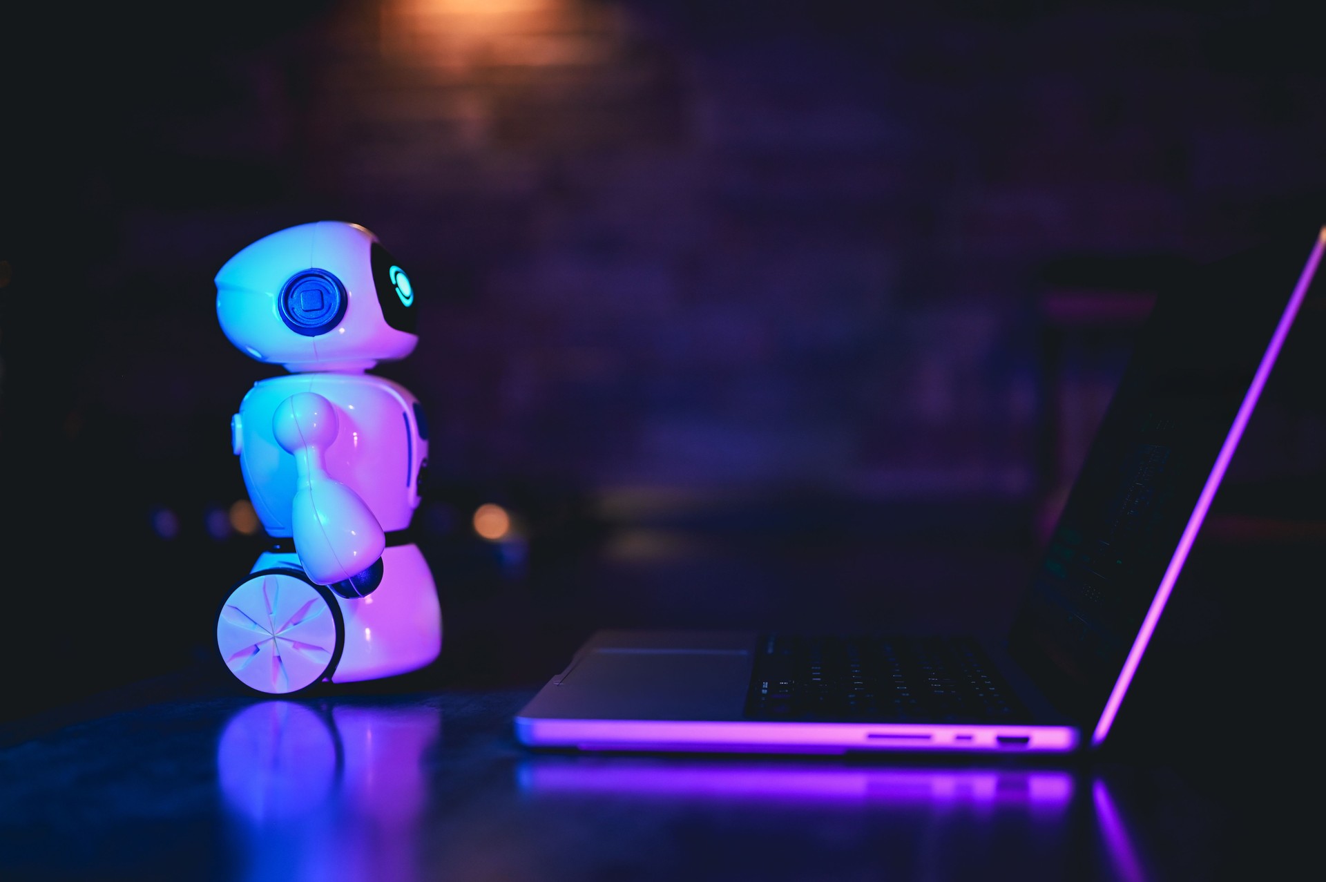 AI chatbot looking at a laptop/ breaching data concept.